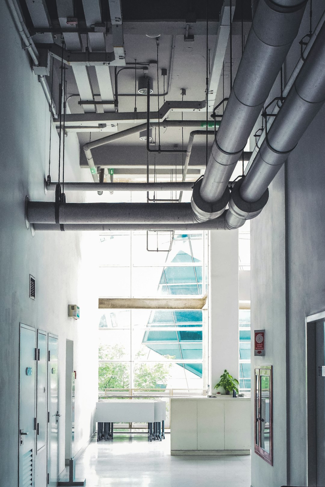 a-room-with-a-lot-of-pipes-hanging-from-the-ceiling-30fvycpwnkq